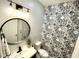 Modern bathroom with black and white patterned tile at 2178 Cooper Bell Pl, Kissimmee, FL 34747