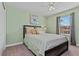 Light green bedroom with a double bed and decorative pillows at 8984 Stinger Dr, Champions Gate, FL 33896