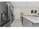 Modern kitchen with gray cabinets, white countertops, and stainless steel appliances at 8984 Stinger Dr, Champions Gate, FL 33896