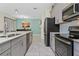 Modern kitchen with gray cabinets, white countertops, and stainless steel appliances at 8984 Stinger Dr, Champions Gate, FL 33896