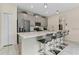 Modern kitchen with gray cabinets, white countertops, and stainless steel appliances at 8984 Stinger Dr, Champions Gate, FL 33896