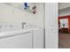 Laundry room with washer, dryer, and shelving at 8984 Stinger Dr, Champions Gate, FL 33896