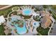 Aerial view of community pool, clubhouse, and landscaping at 8984 Stinger Dr, Champions Gate, FL 33896