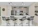 Modern kitchen island with seating and stainless steel appliances at 8984 Stinger Dr, Champions Gate, FL 33896
