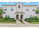 Two-story townhome with light gray siding and two-car driveway at 8984 Stinger Dr, Champions Gate, FL 33896