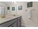 Bathroom with double vanity and mirror at 8984 Stinger Dr, Champions Gate, FL 33896