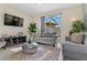 Comfortable living room with two sofas, a coffee table, and a TV at 8984 Stinger Dr, Champions Gate, FL 33896