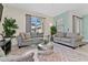 Living room with gray sofas, coffee table, and access to a patio at 8984 Stinger Dr, Champions Gate, FL 33896