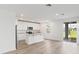 Modern kitchen with island, stainless steel appliances, and access to backyard at 1128 Griffon Ave, Lake Alfred, FL 33850