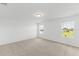 Spacious bedroom with carpeted floor and two windows at 1128 Griffon Ave, Lake Alfred, FL 33850