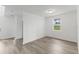 Spacious living room with wood-look flooring at 1128 Griffon Ave, Lake Alfred, FL 33850