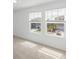 Bright bedroom with carpet and two windows at 1128 Griffon Ave, Lake Alfred, FL 33850