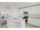 Modern kitchen with white cabinets and granite island at 1128 Griffon Ave, Lake Alfred, FL 33850