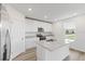 Modern kitchen with island and stainless steel appliances at 1128 Griffon Ave, Lake Alfred, FL 33850