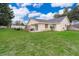 Large backyard with grassy lawn, partially fenced, and patio at 132 Robbins Rest Cir, Davenport, FL 33896