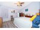 Main bedroom with ceiling fan and wood-look flooring at 132 Robbins Rest Cir, Davenport, FL 33896