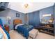 Blue bedroom with a twin bed and plenty of storage at 132 Robbins Rest Cir, Davenport, FL 33896