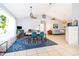 Bright dining area with a table, chairs, and decorative rug at 132 Robbins Rest Cir, Davenport, FL 33896