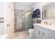 Updated bathroom with gray tile shower, modern vanity, and glass enclosure at 132 Robbins Rest Cir, Davenport, FL 33896