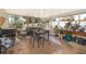 Spacious screened porch with dining table, rocking chairs, and lush plants at 132 Robbins Rest Cir, Davenport, FL 33896