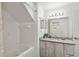 Bathroom with tub, shower, granite vanity, and updated fixtures at 2211 San Vittorino Cir # 105, Kissimmee, FL 34741