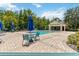Community pool with patio furniture and cabana at 2211 San Vittorino Cir # 105, Kissimmee, FL 34741