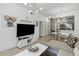 Open concept living room featuring a sectional sofa and large TV at 2211 San Vittorino Cir # 105, Kissimmee, FL 34741