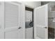 A laundry closet with a stacked washer and dryer, and additional storage at 2211 San Vittorino Cir # 105, Kissimmee, FL 34741