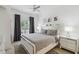 Bright bedroom with a queen-size bed, gray bedding, and a ceiling fan at 2211 San Vittorino Cir # 105, Kissimmee, FL 34741
