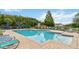 Inviting community pool with lounge chairs and umbrellas at 2211 San Vittorino Cir # 105, Kissimmee, FL 34741