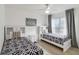 Bright bedroom with twin beds, built-in shelving, and window coverings at 2211 San Vittorino Cir # 105, Kissimmee, FL 34741
