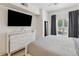 Bedroom with king-size bed, dresser, and large TV at 2211 San Vittorino Cir # 105, Kissimmee, FL 34741