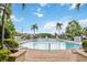 Community pool with water features and lounge chairs at 2211 San Vittorino Cir # 105, Kissimmee, FL 34741