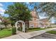 Townhome with peach siding and white arbor, located in a community setting at 2211 San Vittorino Cir # 105, Kissimmee, FL 34741