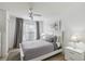 Bedroom with a queen-size bed, gray bedding, and a ceiling fan at 2211 San Vittorino Cir # 105, Kissimmee, FL 34741
