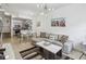 Open concept living room with modern furniture and a stylish chandelier at 2211 San Vittorino Cir # 105, Kissimmee, FL 34741