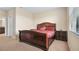 Spacious bedroom with carpeting, large window and a dark wood bed frame at 8940 Azalea Sands Ln # 8940, Davenport, FL 33896