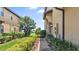 Landscaped side yard with a walkway leading to the home entrance at 8940 Azalea Sands Ln # 8940, Davenport, FL 33896