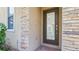 Modern dark brown front door entry with stone accents at 8940 Azalea Sands Ln # 8940, Davenport, FL 33896