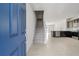 Bright entryway with blue door and view of stairs and kitchen at 2609 Bright Jewel St # 2909, Kissimmee, FL 34746