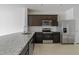 Modern kitchen with dark cabinets and stainless steel appliances at 2609 Bright Jewel St # 2909, Kissimmee, FL 34746