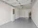 Garage with epoxy floor and door to house at 2609 Bright Jewel St # 2909, Kissimmee, FL 34746