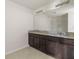 Double vanity bathroom with granite countertop and large mirror at 2609 Bright Jewel St # 2909, Kissimmee, FL 34746