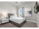 Bright bedroom with a queen bed and large window at 7770 Sandy Ridge Dr # 227, Reunion, FL 34747