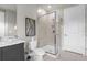 Modern bathroom with a glass shower enclosure and gray vanity at 7770 Sandy Ridge Dr # 227, Reunion, FL 34747