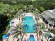 Large community pool with surrounding lounge chairs and umbrellas at 7770 Sandy Ridge Dr # 227, Reunion, FL 34747
