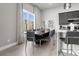 Modern dining room with gray chairs and large window at 7770 Sandy Ridge Dr # 227, Reunion, FL 34747