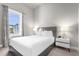 Bedroom with a queen bed and modern nightstand at 7770 Sandy Ridge Dr # 227, Reunion, FL 34747