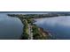 Aerial view of waterfront property with walking path at 30053 Island Club Dr, Tavares, FL 32778