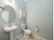 Convenient powder room featuring a pedestal sink and updated toilet at 30053 Island Club Dr, Tavares, FL 32778